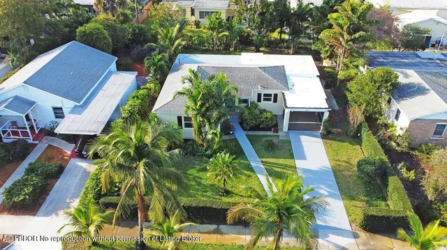an aerial view of a house with swimming pool and garden