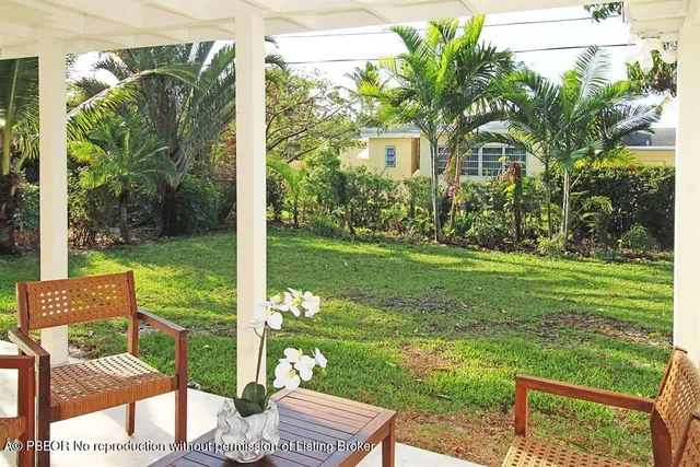 a view of a chairs and table in patio with a yard