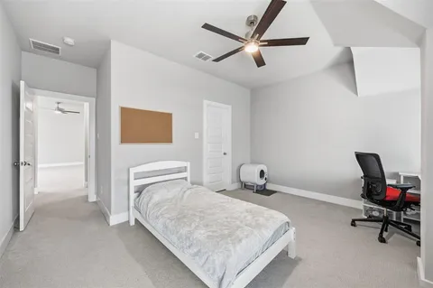 a bedroom with a bed a table and chair