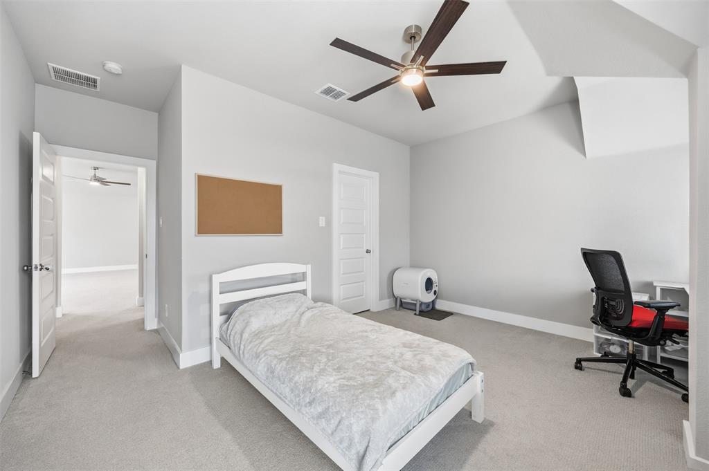 5805 Heatherwood Loop Sachse, TX 75048 - Photo 14 of 39 a bedroom with a bed a table and chair