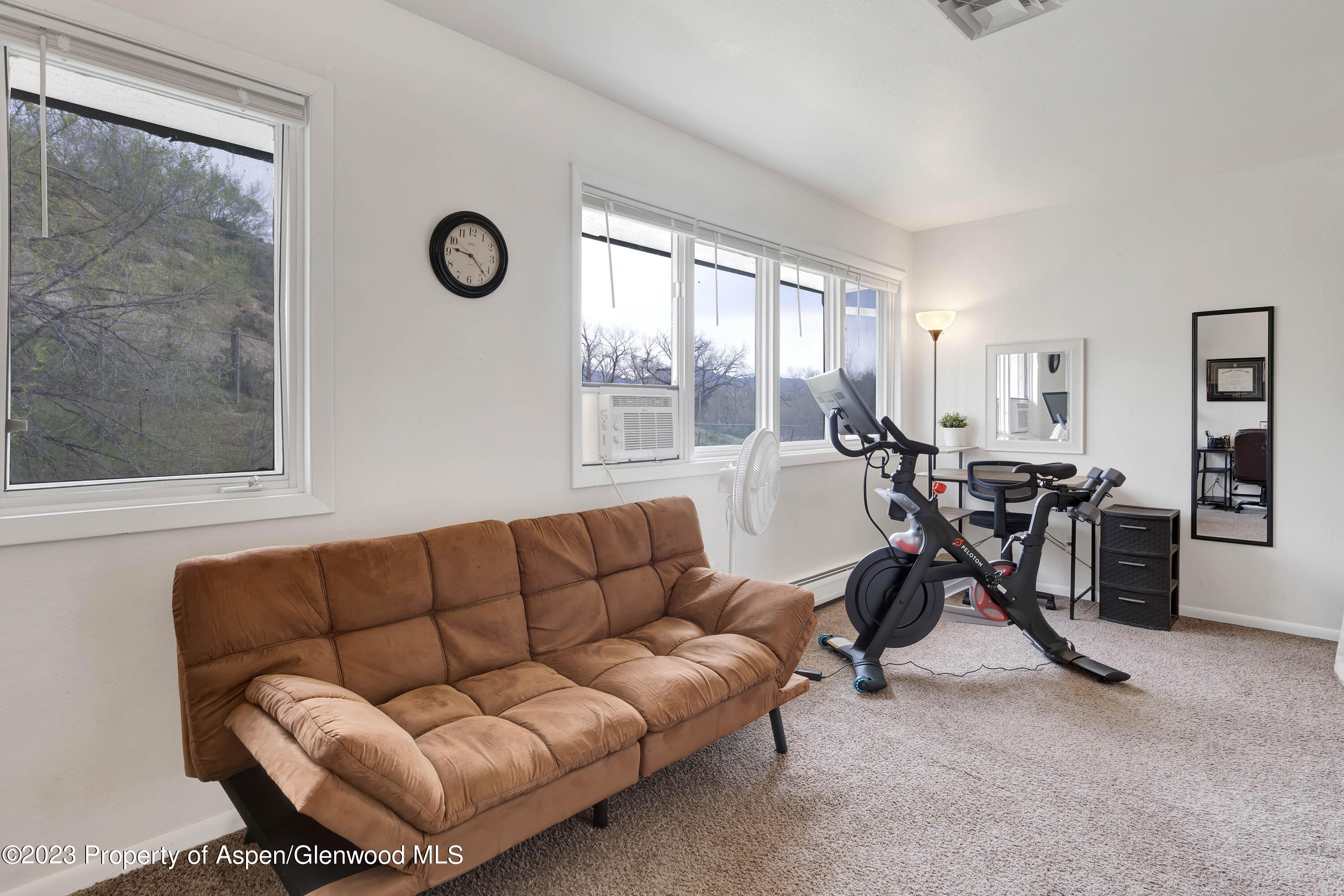 1173 Park Avenue Rifle, CO 81650 - Photo 15 of 26 a living room with furniture a clock and a large window