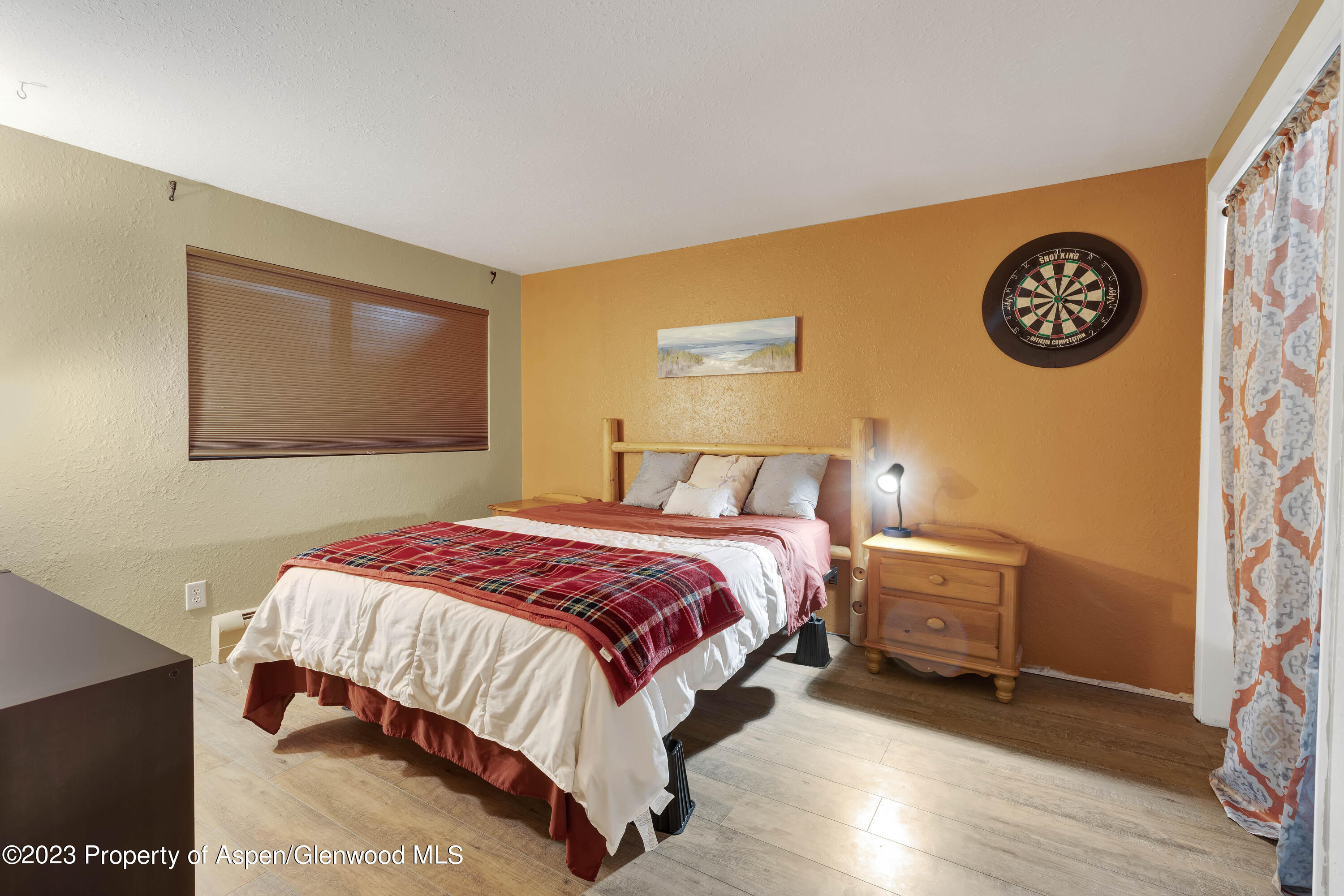 1173 Park Avenue Rifle, CO 81650 - Photo 20 of 26 a bedroom with a bed and a wall painting