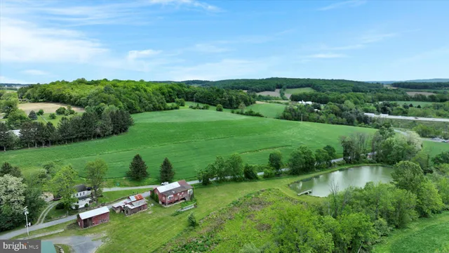 a yard with lots of green space and mountain view in back