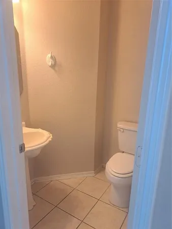 a white toilet sitting next to a shower