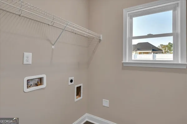 a view of empty room with wooden floor and window
