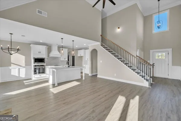a view of a livingroom with a fireplace wooden floor and windows