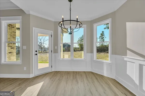 a view of empty room with wooden floor and ceiling fan