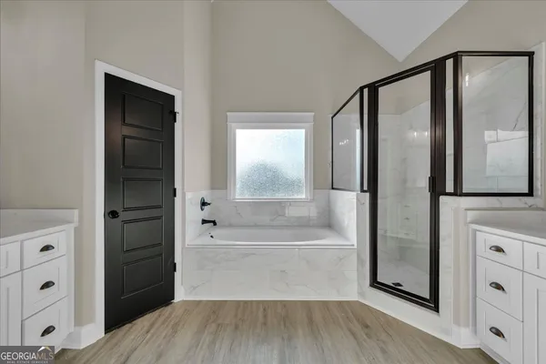 a en suite bathroom with a granite countertop sink and a mirror