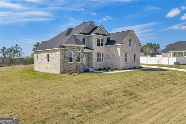 a front view of a house with a garden