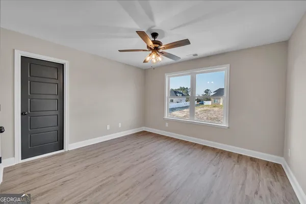 a view of a big room with wooden floor and closet