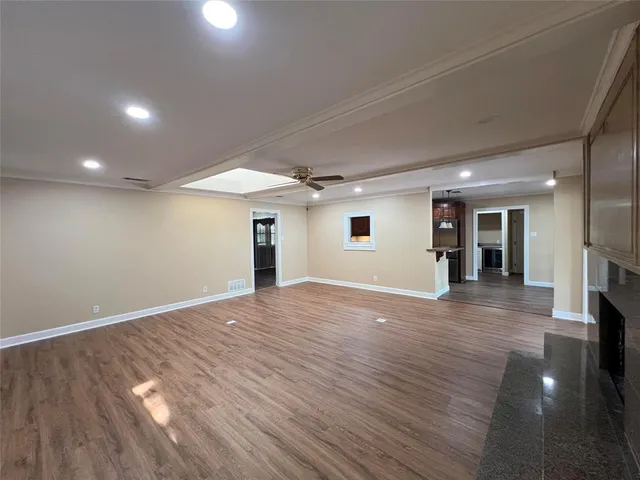 an empty room with wooden floor and a window