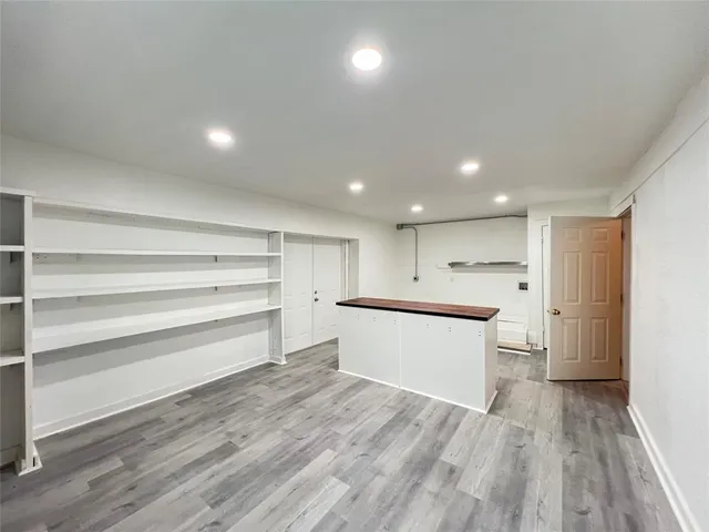 an empty room with wooden floor