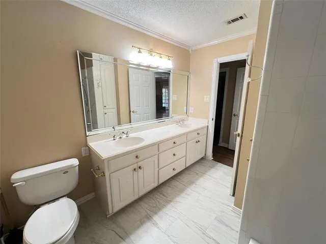 a spacious bathroom with a double vanity sink and a mirror