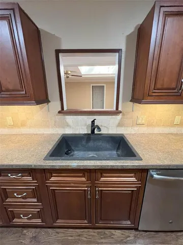 a sink with granite countertop a sink and a stove