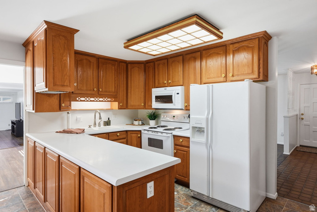 2524 Camelback Road Cottonwood Heights, UT 84121 - Photo 18 of 49 Kitchen featuring wood cabinetry, white countertops, a white refrigerator, and a built-in microwave