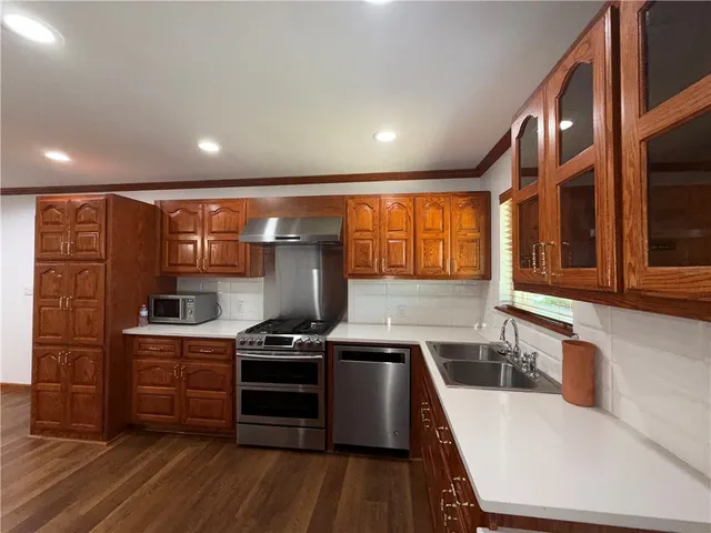 a kitchen with stainless steel appliances granite countertop a stove and a refrigerator
