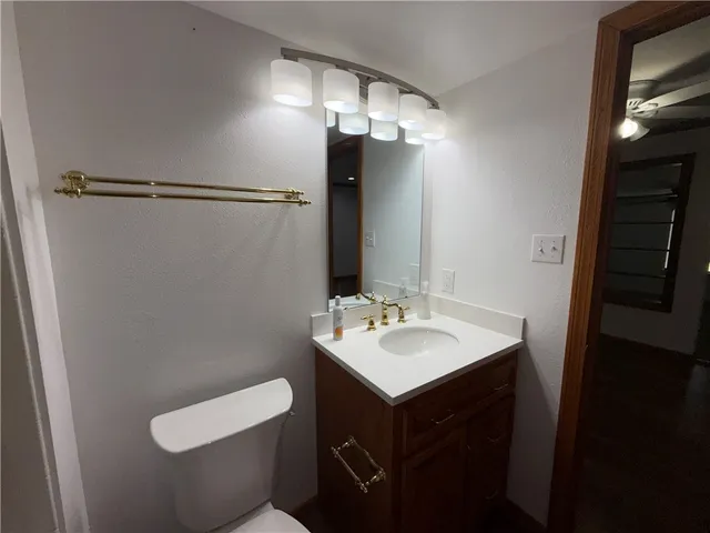 a bathroom with a sink toilet and mirror