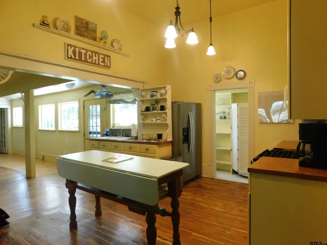 a room with pool table and wooden floor