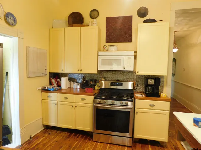 a kitchen with a sink a stove and cabinets