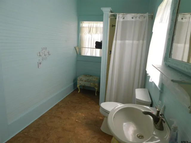 a bathroom with a sink a toilet and tub
