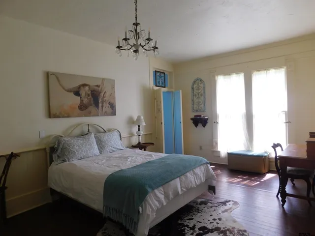 a bedroom with bed furniture and a window
