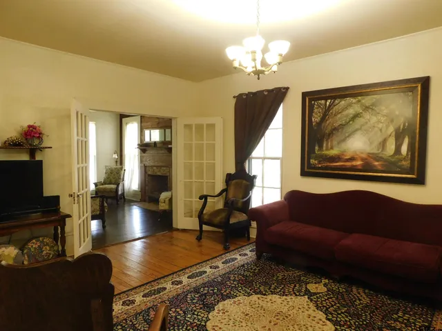 a living room with furniture and a chandelier