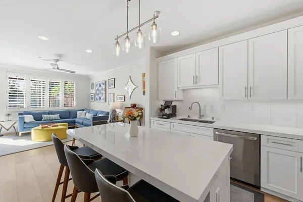 a kitchen with a table chairs sink and cabinets