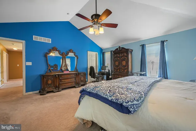 a bedroom with a bed and a dresser in it