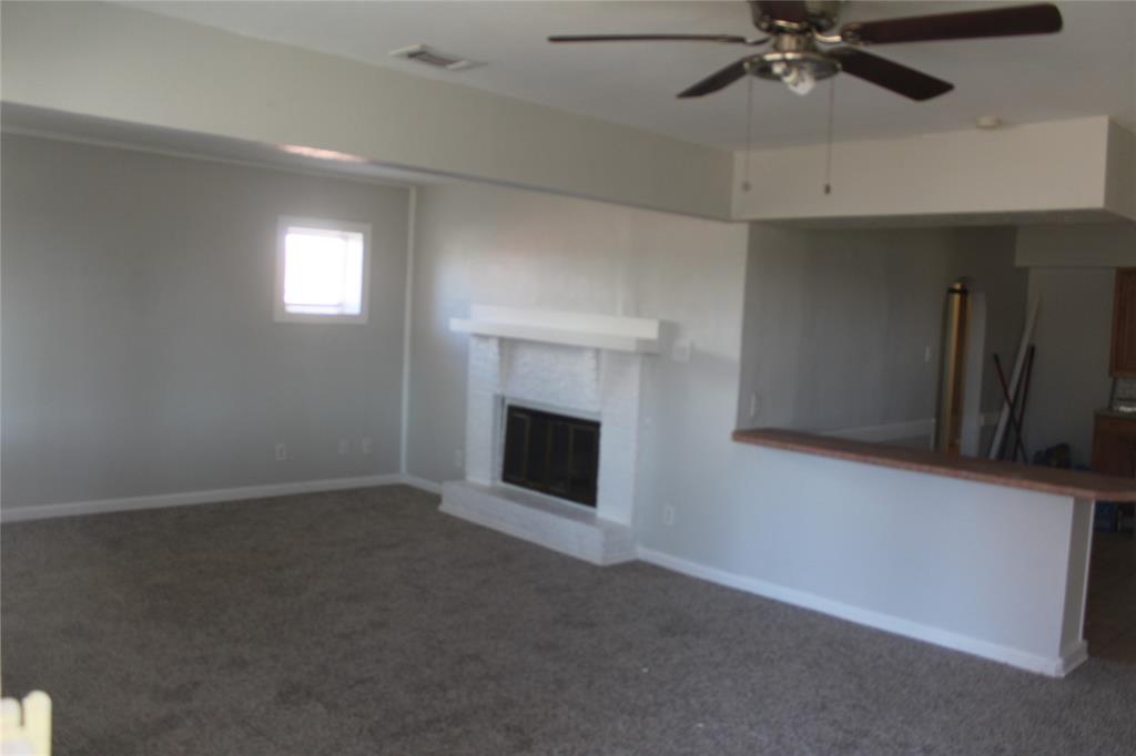1010 Appleblossom Lane Mesquite, TX 75149 - Photo 16 of 16 an empty room with windows and fireplace