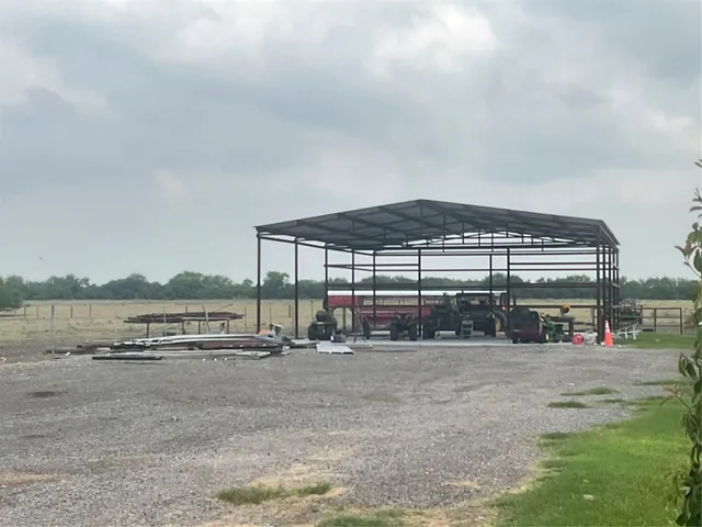 a view of water with a big yard and large trees