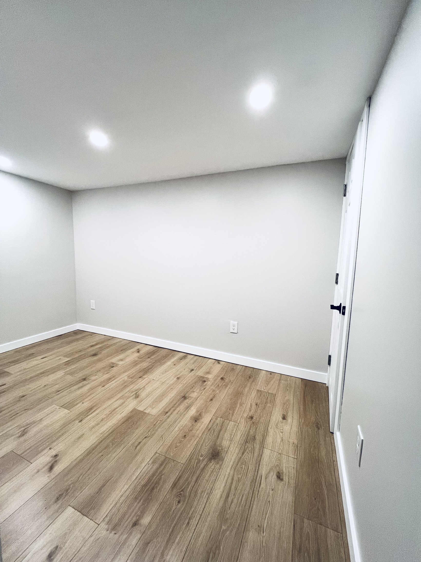 8 Rustic Road Ridgefield, CT 06877 - Photo 14 of 18 an empty room with wooden floor and white walls