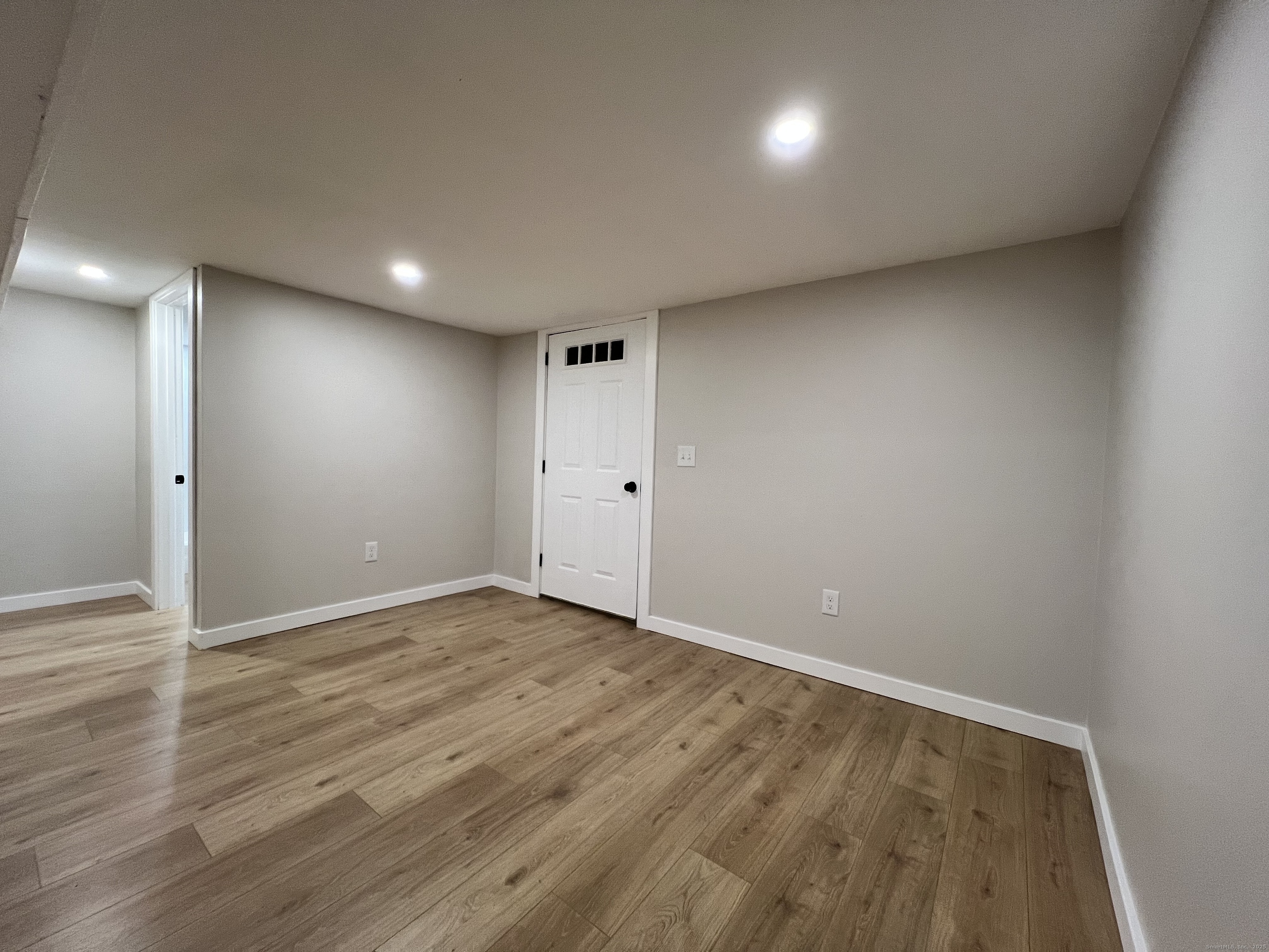 8 Rustic Road Ridgefield, CT 06877 - Photo 16 of 18 an empty room with wooden floor and windows