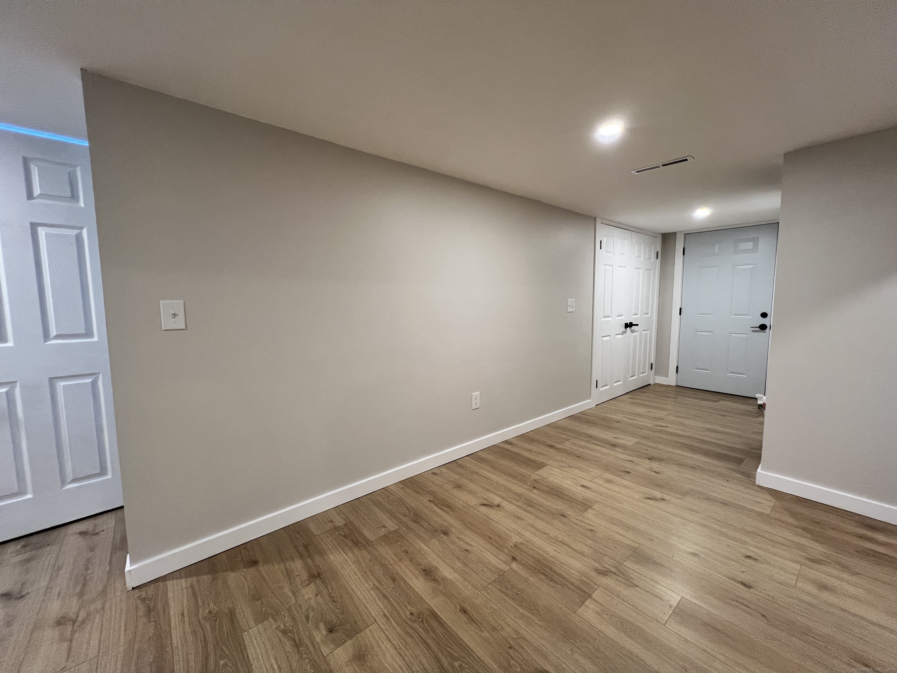8 Rustic Road Ridgefield, CT 06877 - Photo 17 of 18 a view of an empty room with wooden floor