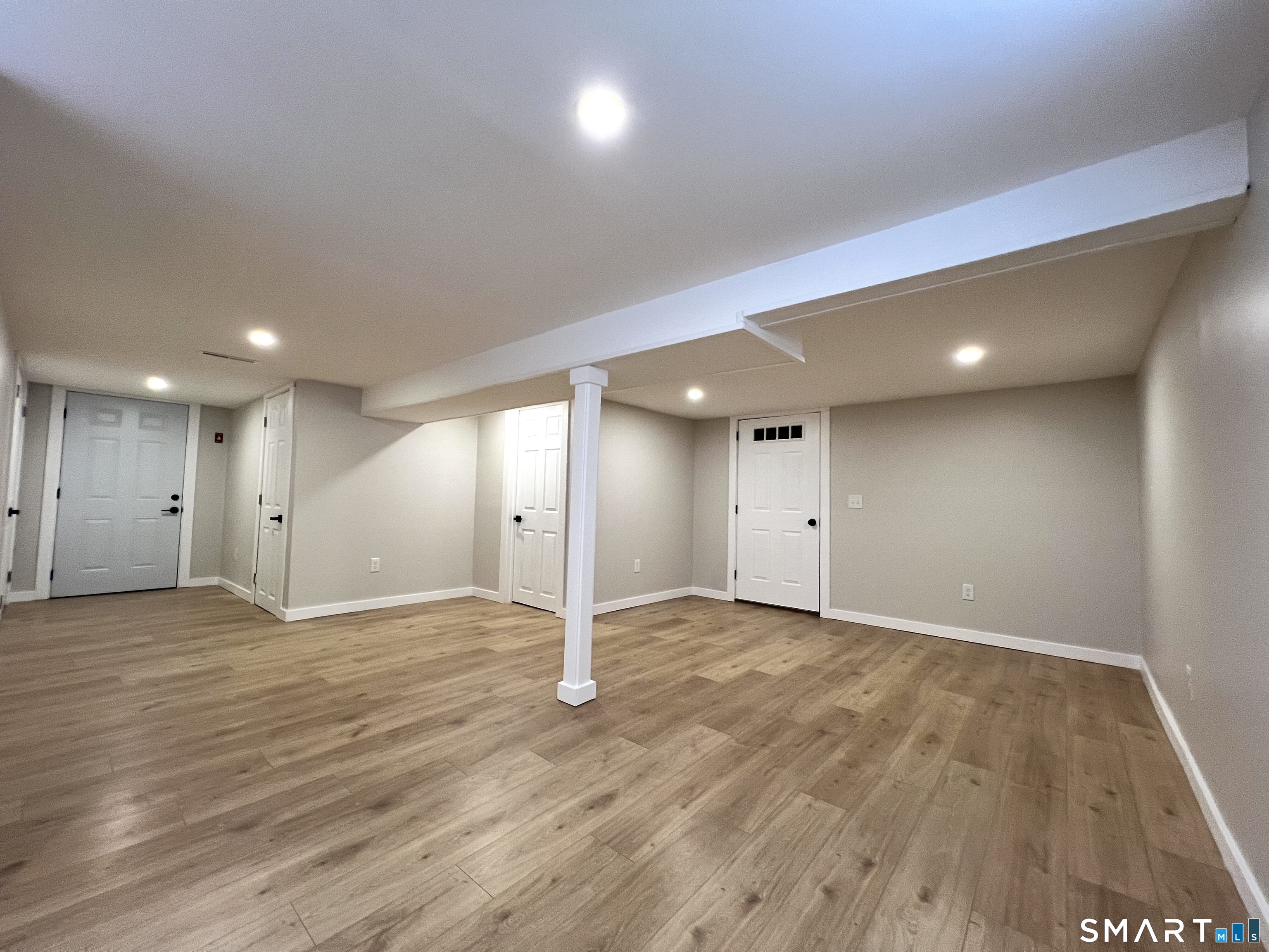 8 Rustic Road Ridgefield, CT 06877 - Photo 18 of 20 an empty room with wooden floor and natural light