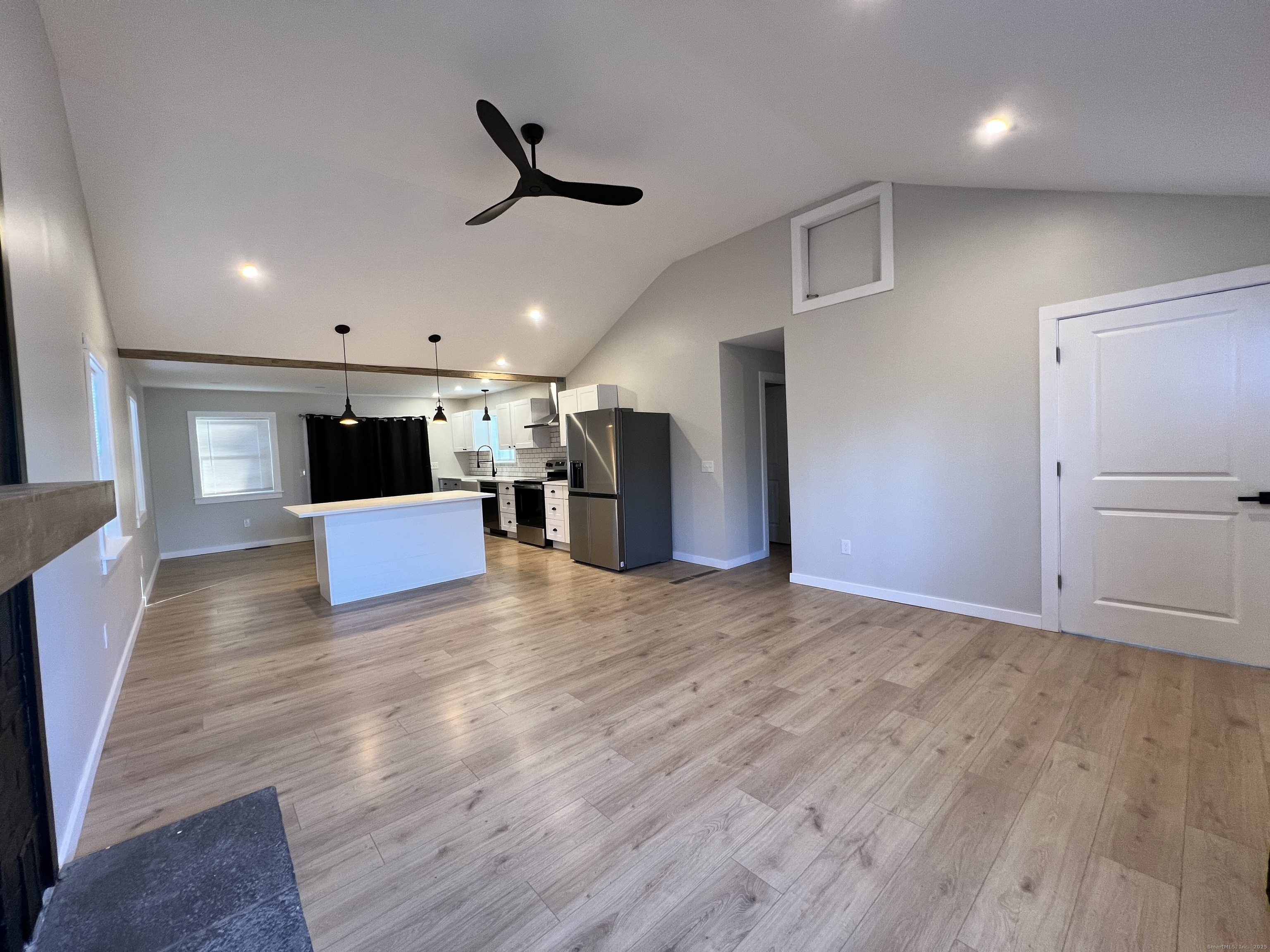 8 Rustic Road Ridgefield, CT 06877 - Photo 2 of 18 a view of kitchen with refrigerator microwave and wooden floor