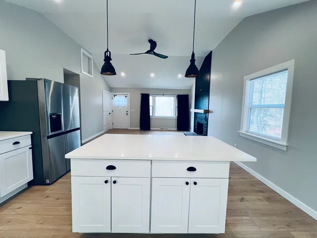 a very nice looking room with a large window and wooden floor