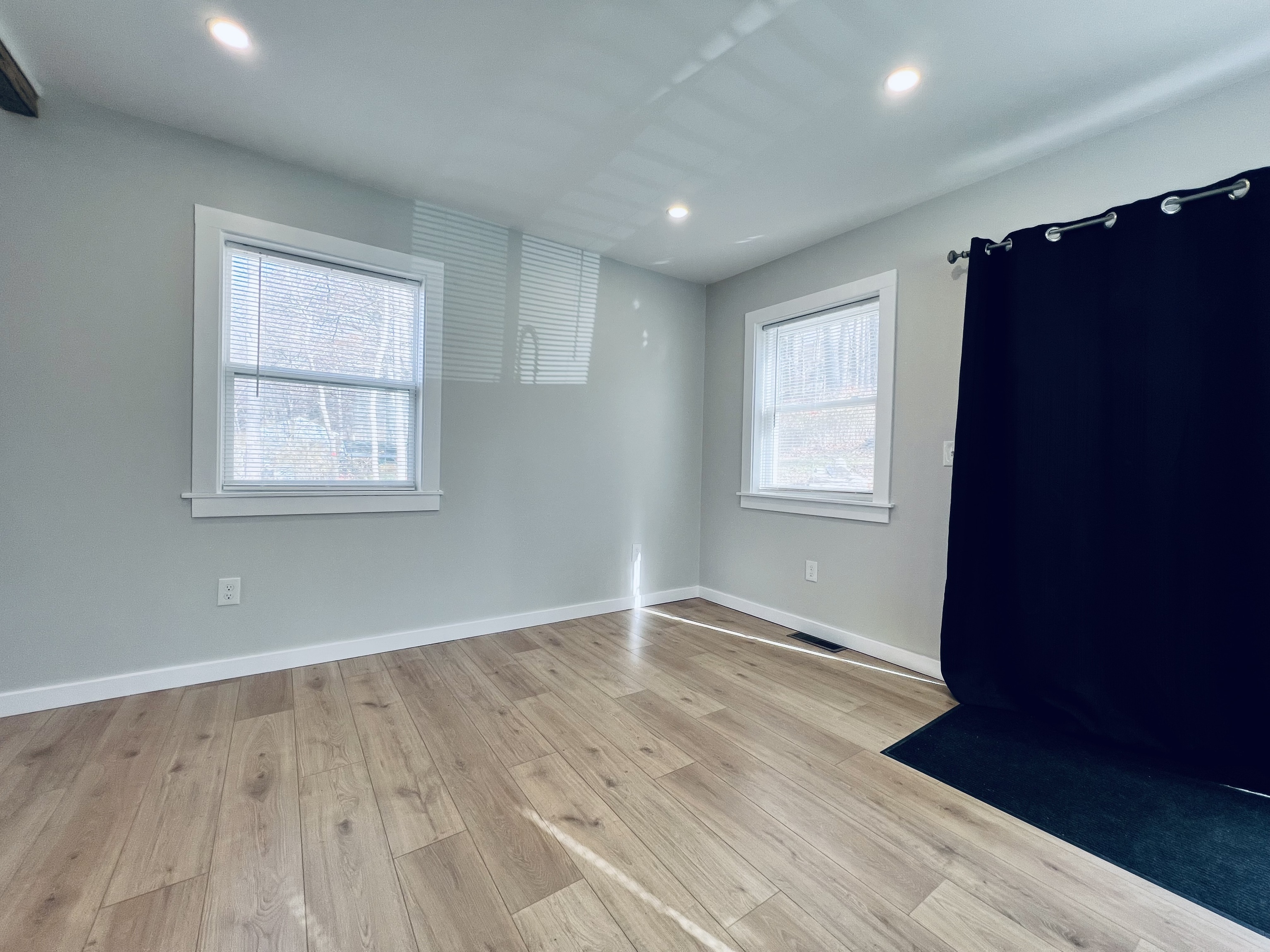 8 Rustic Road Ridgefield, CT 06877 - Photo 6 of 18 an empty room with wooden floor and windows