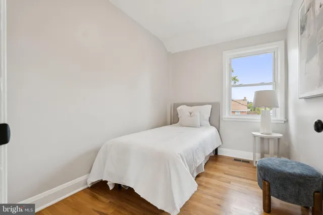 a bedroom with a bed and chair