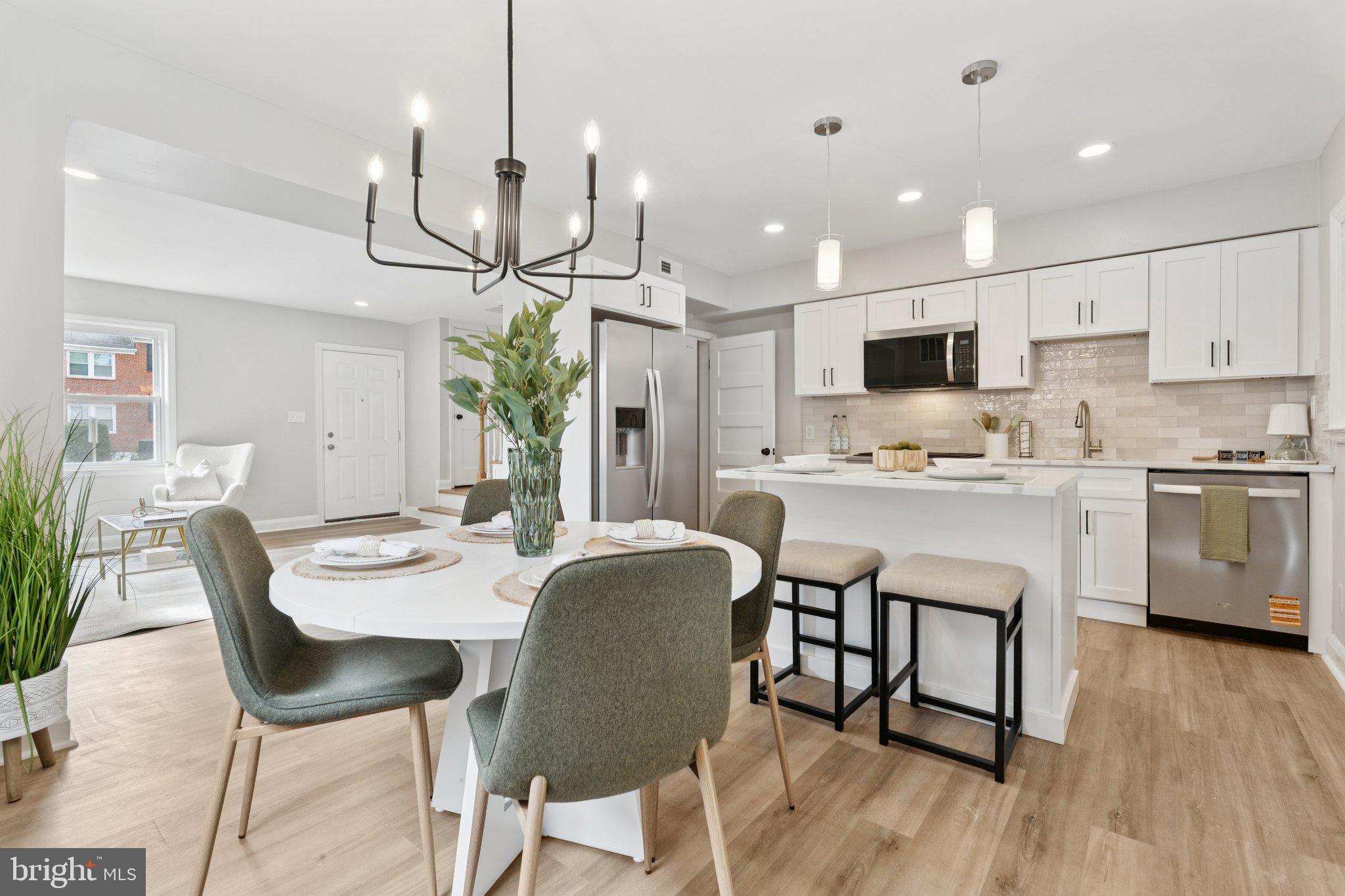 1014 Upnor Road Baltimore, MD 21212 - Photo 5 of 25 a kitchen with kitchen island a dining table and chairs