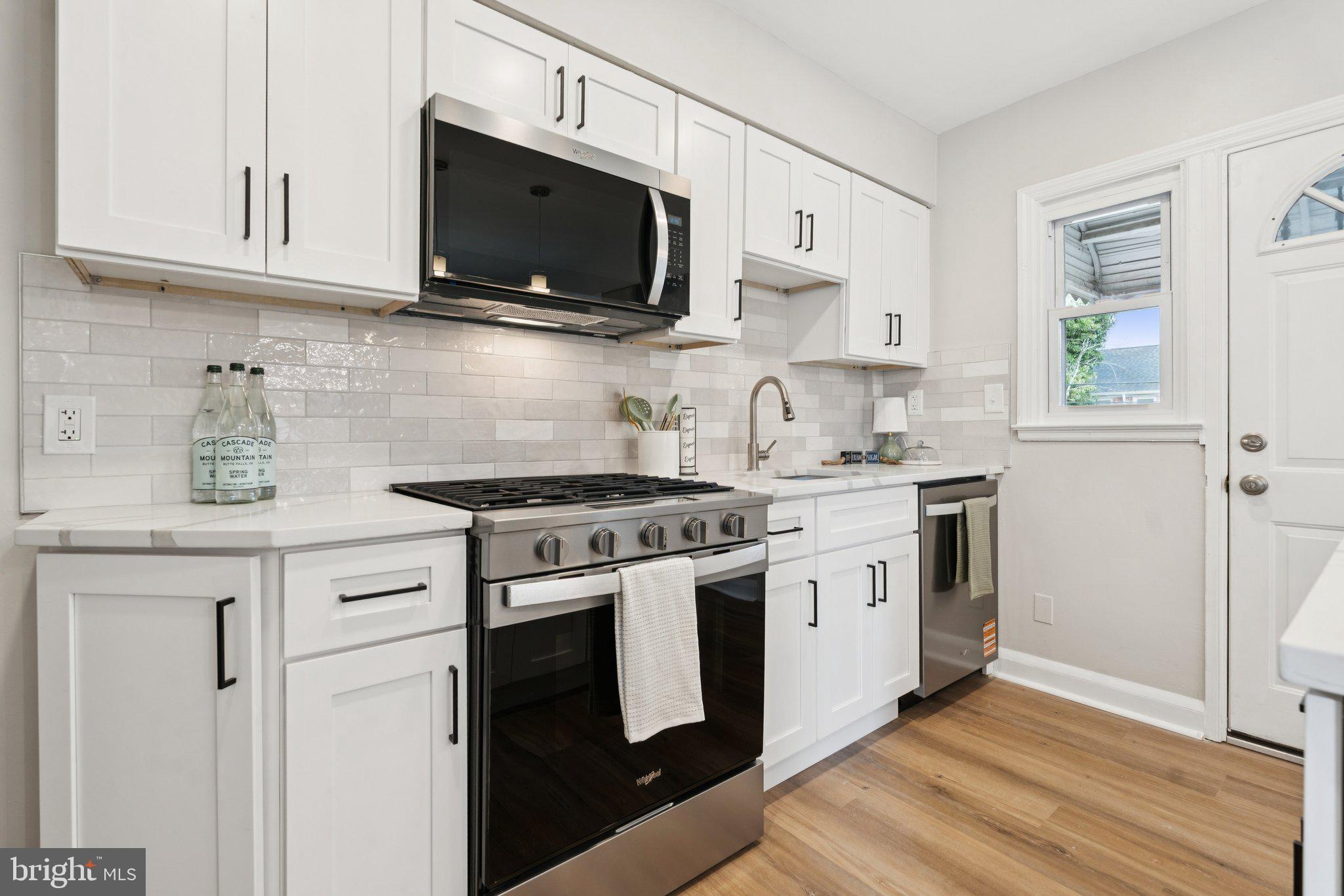 1014 Upnor Road Baltimore, MD 21212 - Photo 7 of 25 a kitchen with stainless steel appliances granite countertop a sink a stove and a microwave