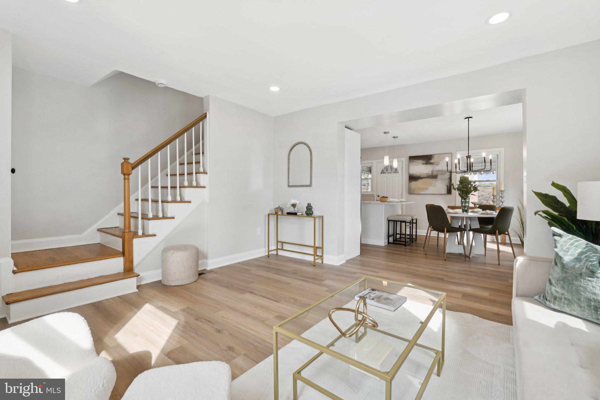 1014 Upnor Road Baltimore, MD 21212 - Photo 9 of 25 a living room with furniture a dining table and a potted plant