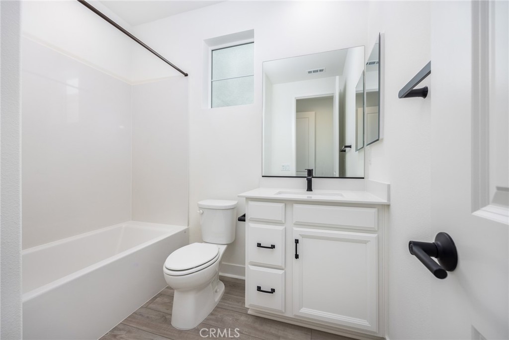 478 Chorus Irvine, CA 92618 - Photo 12 of 33 a bathroom with a toilet sink a mirror and shower