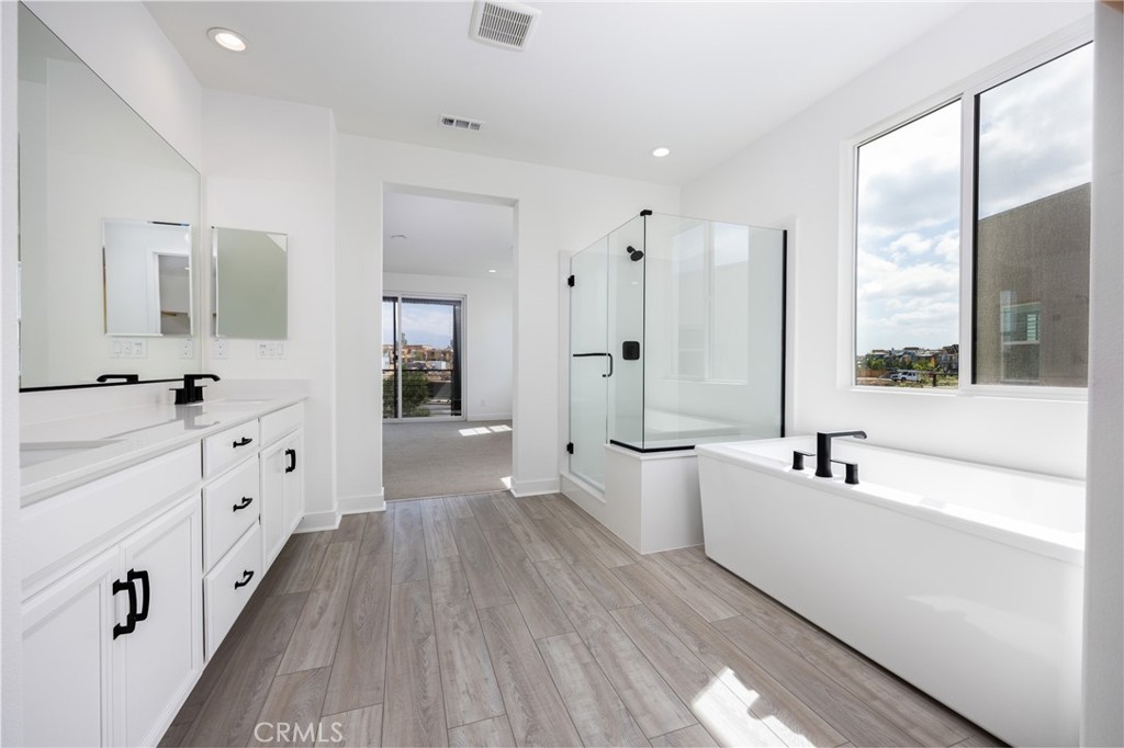 478 Chorus Irvine, CA 92618 - Photo 16 of 33 a large white bathroom with a large tub sink shower and mirror