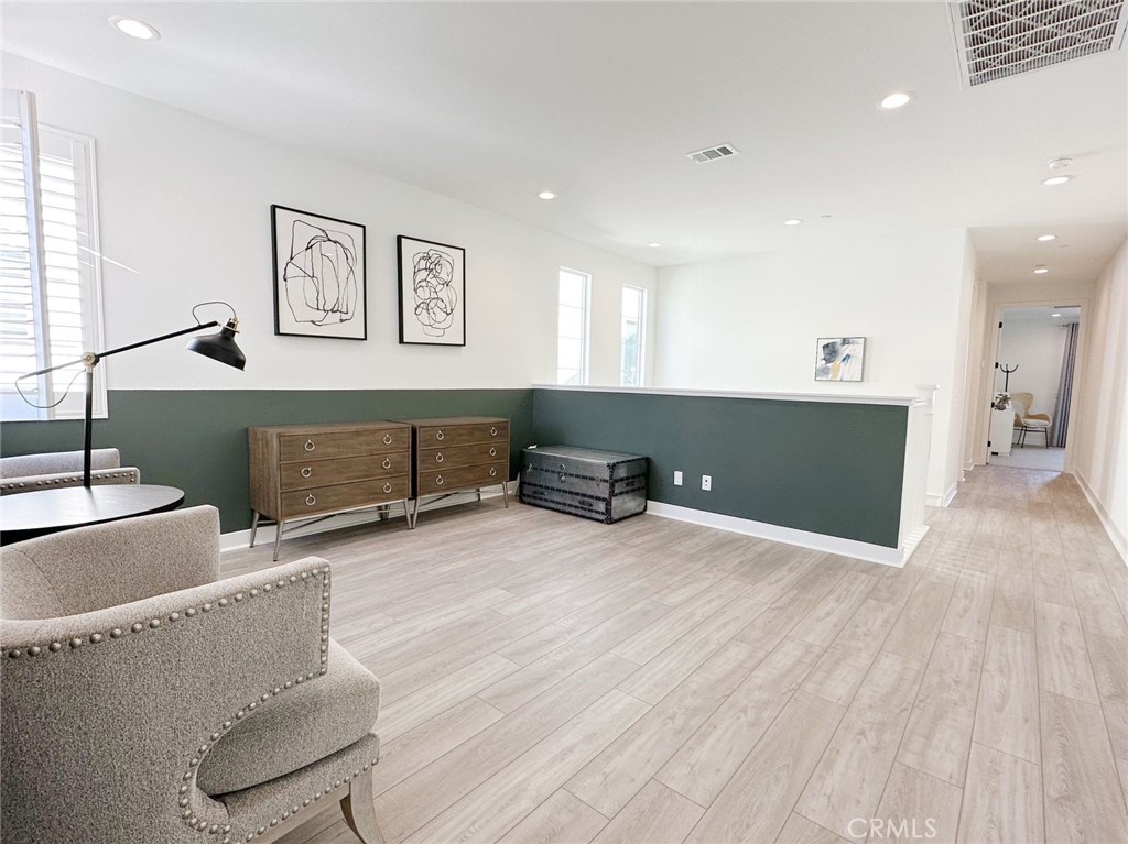 478 Chorus Irvine, CA 92618 - Photo 18 of 33 a living room with furniture and a wooden floor