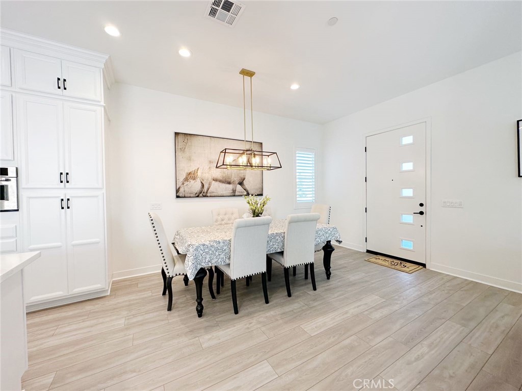 478 Chorus Irvine, CA 92618 - Photo 5 of 33 a view of a dining room with furniture and wooden floor