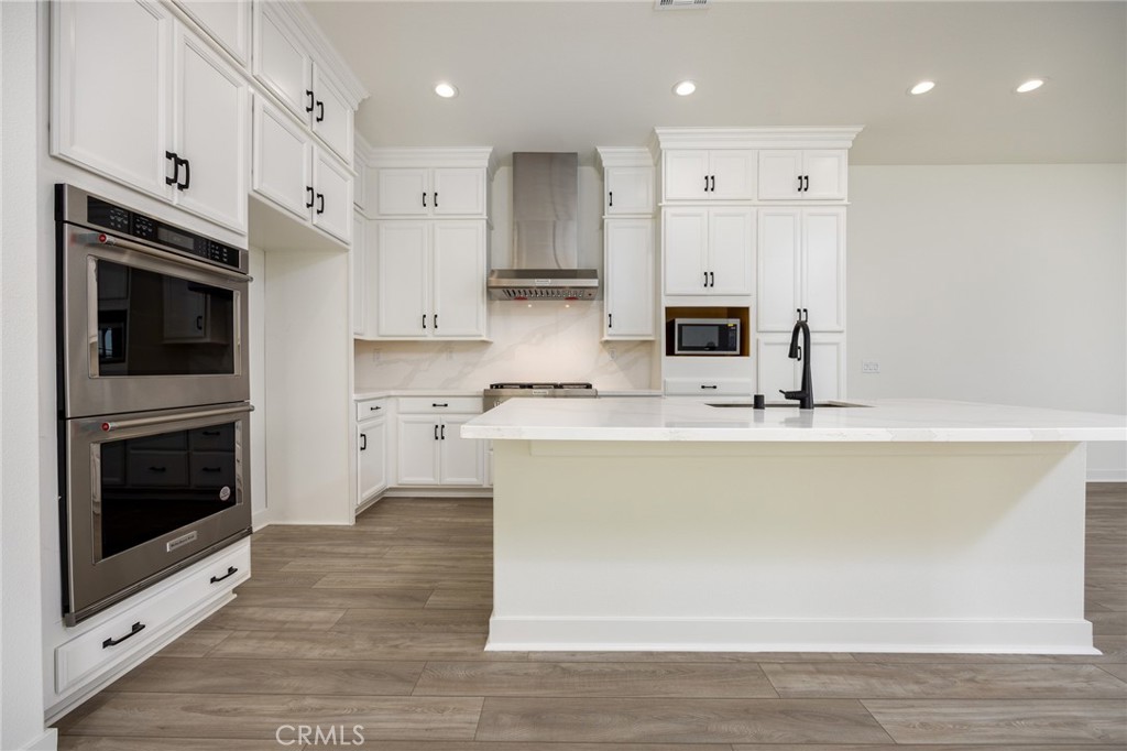 478 Chorus Irvine, CA 92618 - Photo 6 of 33 a kitchen with stainless steel appliances granite countertop a stove a sink and a microwave