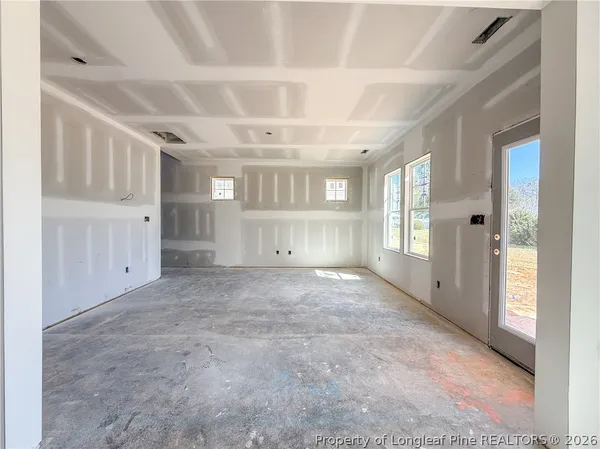 an empty room with windows and closet