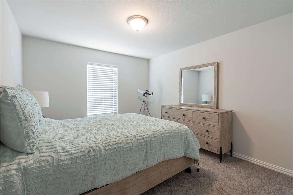 1141 Rusk Way Lewisville, TX 75077 - Photo 15 of 20 a bedroom with a bed and a mirror