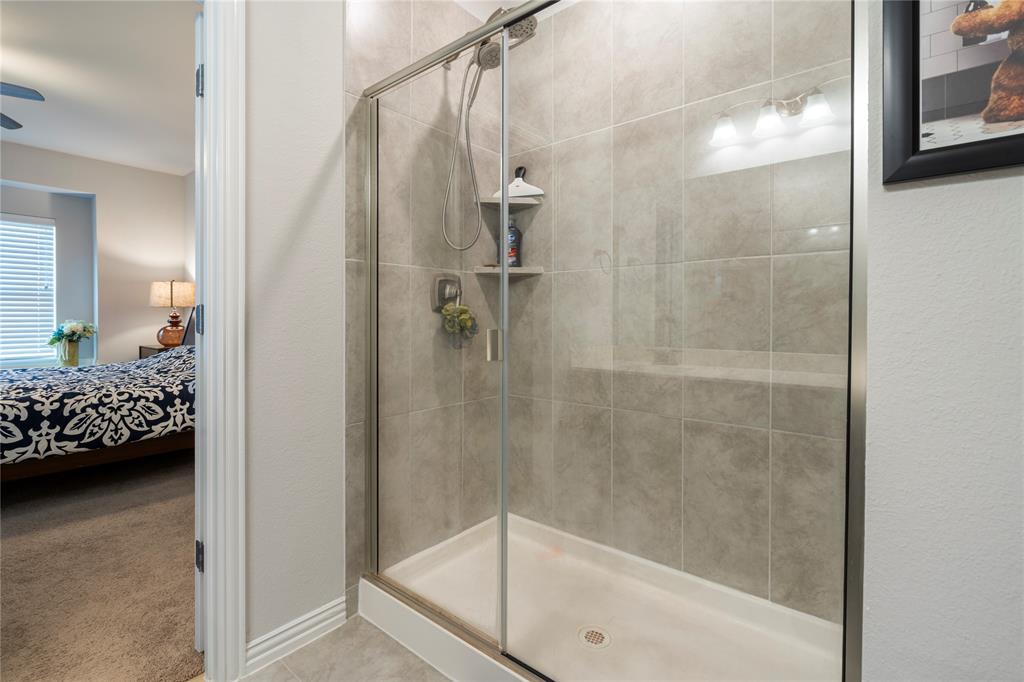 1141 Rusk Way Lewisville, TX 75077 - Photo 10 of 20 a bathroom with a bathtub and a shower
