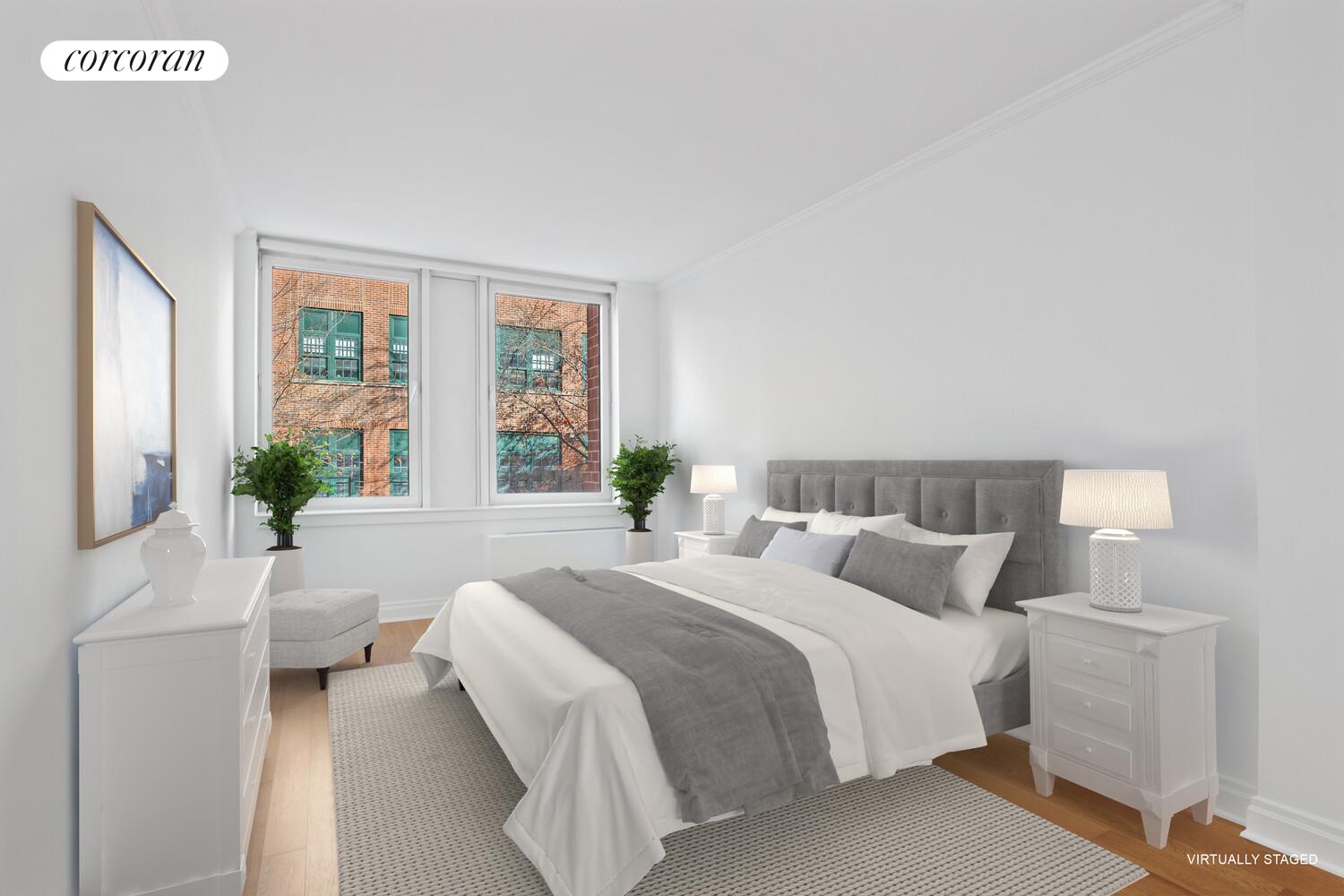 404 East 76th Street, Unit 2J Manhattan, NY 10021 - Photo 6 of 9 a bedroom with a large bed and a large window